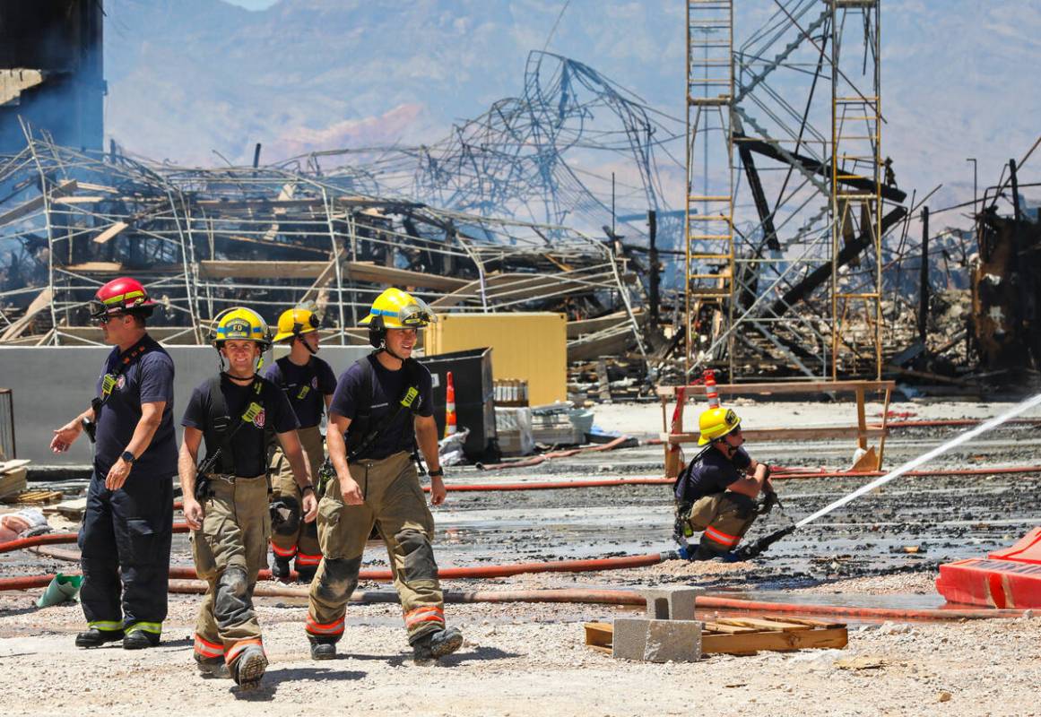 Firefighters work on a fire in an apartment complex under construction at 8030 W. Maule Ave on ...