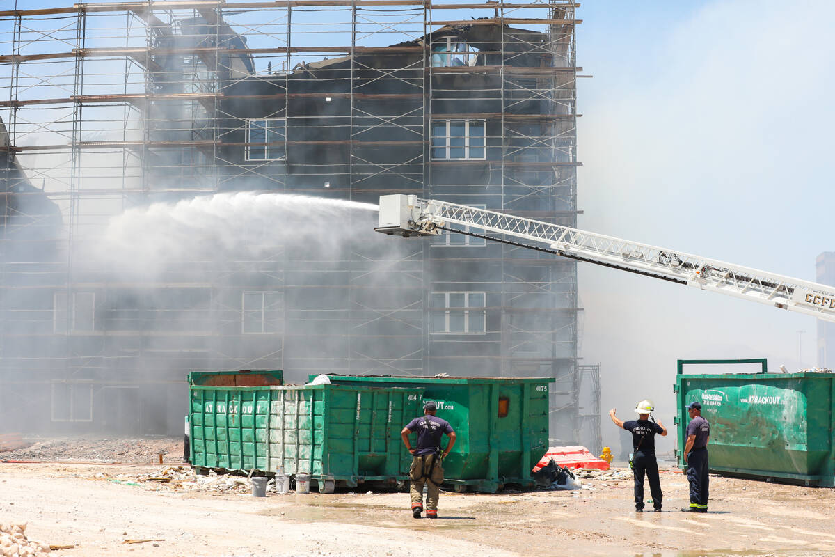 Firefighters work on a fire in an apartment complex under construction at 8030 W. Maule Ave on ...