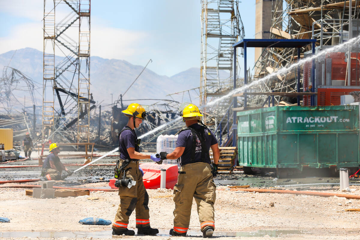 Firefighters work on a fire in an apartment complex under construction at 8030 W. Maule Ave on ...
