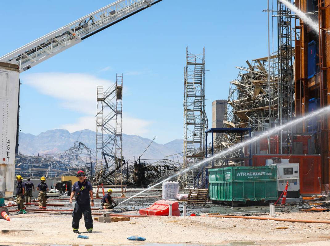 Firefighters work on a fire in an apartment complex under construction at 8030 W. Maule Ave on ...