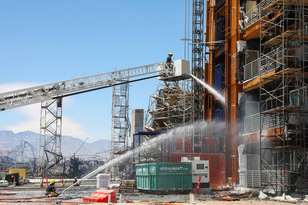 Firefighters work on a fire in an apartment complex under construction at 8030 W. Maule Ave on ...