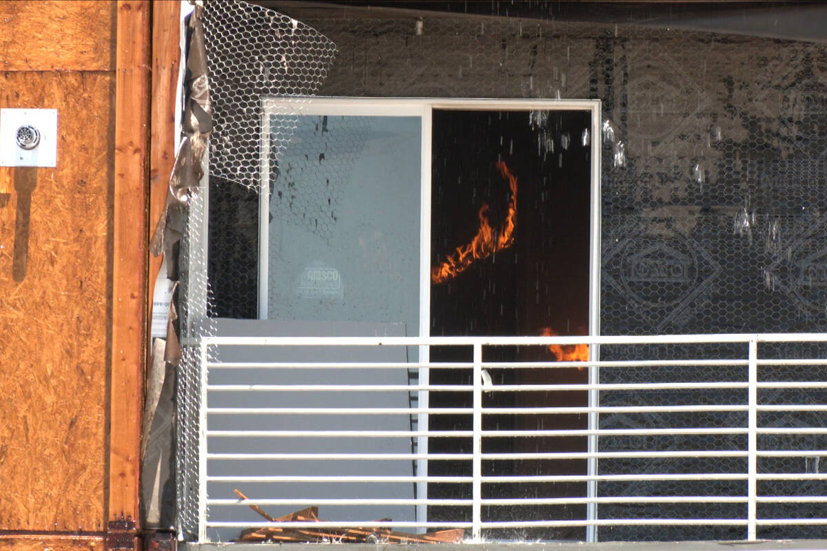 Flames continue to flare up from a fire at an apartment complex under construction at 8030 W. M ...