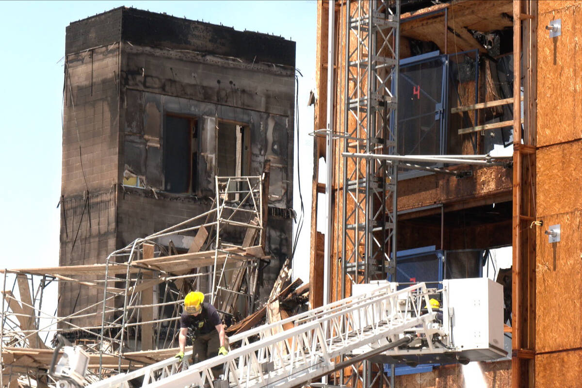 Firefighters work on a fire at an apartment complex under construction at 8030 W. Maule Ave. in ...