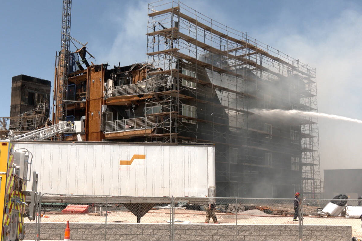 Firefighters pour water on a fire at an apartment complex under construction at 8030 W. Maule A ...