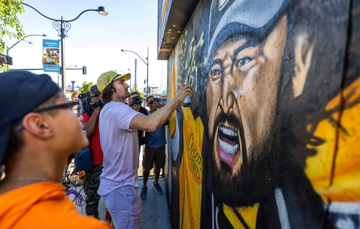 Golden Knights Mark Stone with artist Juan Ochoa signs a new mural of the him painted holding t ...