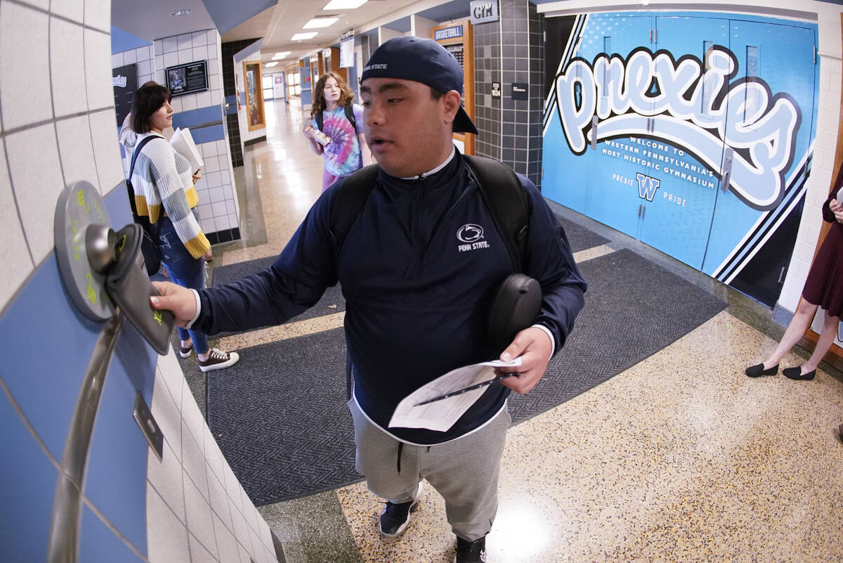 Anthony Bruno, a student at the Washington Junior High School, uses the unlocking mechanism as ...