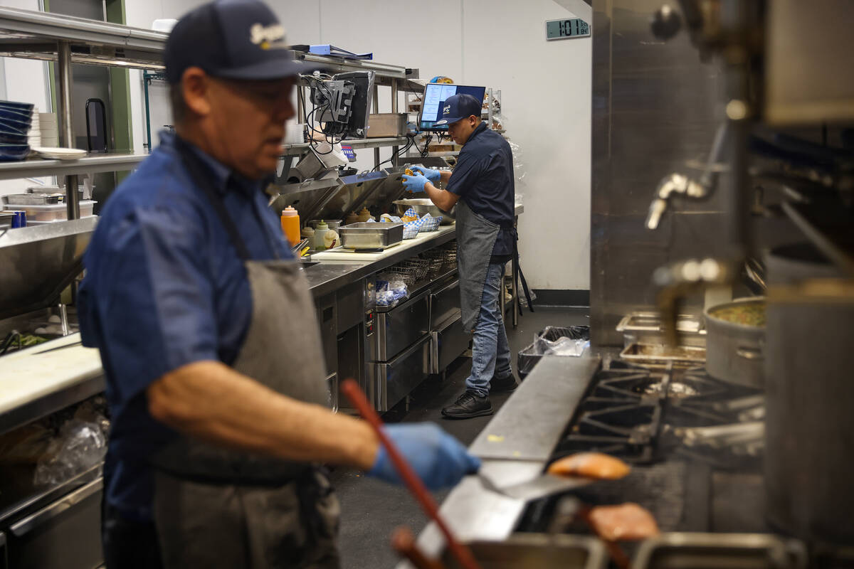 Juan Lujna, left, and Jose Aleman, right, cook in the kitchen at Saginaw’s Deli at Circa ...