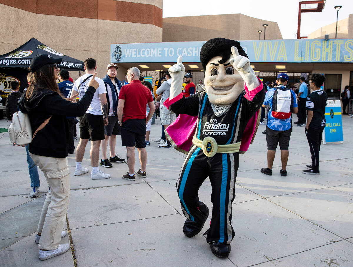 The Las Vegas Lights FC mascot “Cash the Soccer Rocker" entertains fans outside of ...