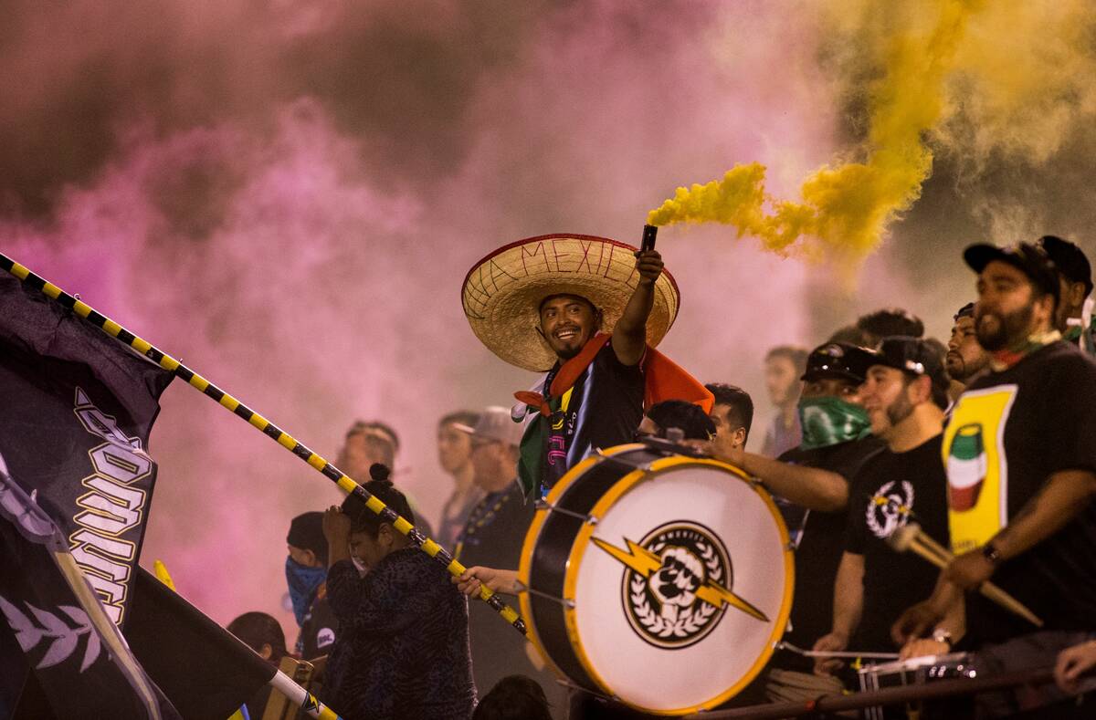 A fan holds up a colored smoke bomb at a Lights game in an undated photo. (Lights FC)