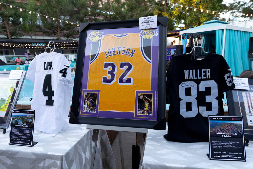 Auction items are displayed during the 3rd annual Concert to SHINE On at the Aria on Thursday, ...