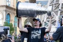Golden Knights captain Mark Stone holds the Stanley Cup as he celebrates with fans during a par ...