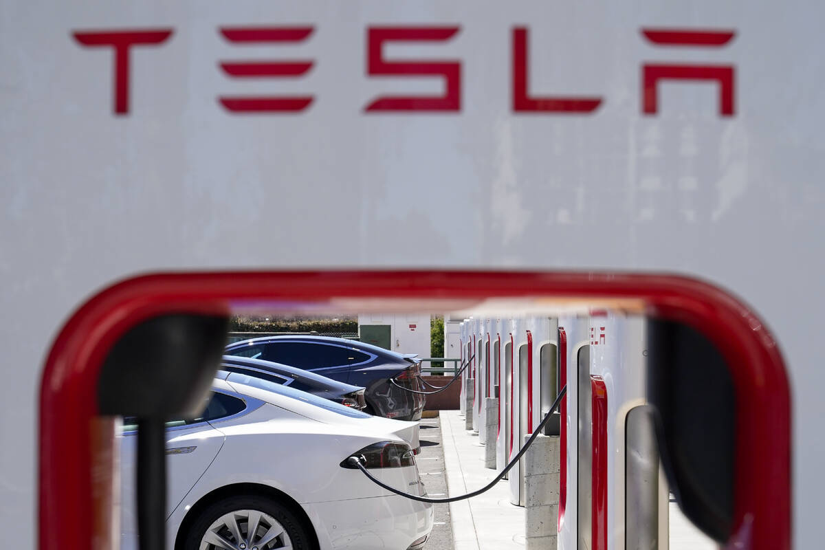 FILE - Tesla vehicles charge at a station in Emeryville, Calif., Aug. 10, 2022. Electric vehicl ...