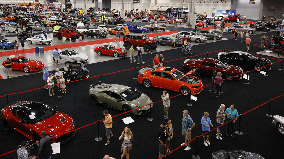 People walk around during the Barrett-Jackson Auction at the Las Vegas Convention Center, Frida ...
