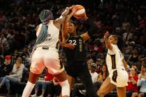 Las Vegas Aces center A'ja Wilson (22) moves the ball around Indiana Fever forward/center Aliya ...