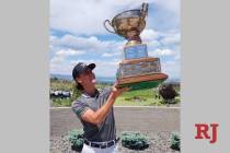 Ben Sawaia admires the championship trophy after winning the Nevada State Amateur at the Club a ...
