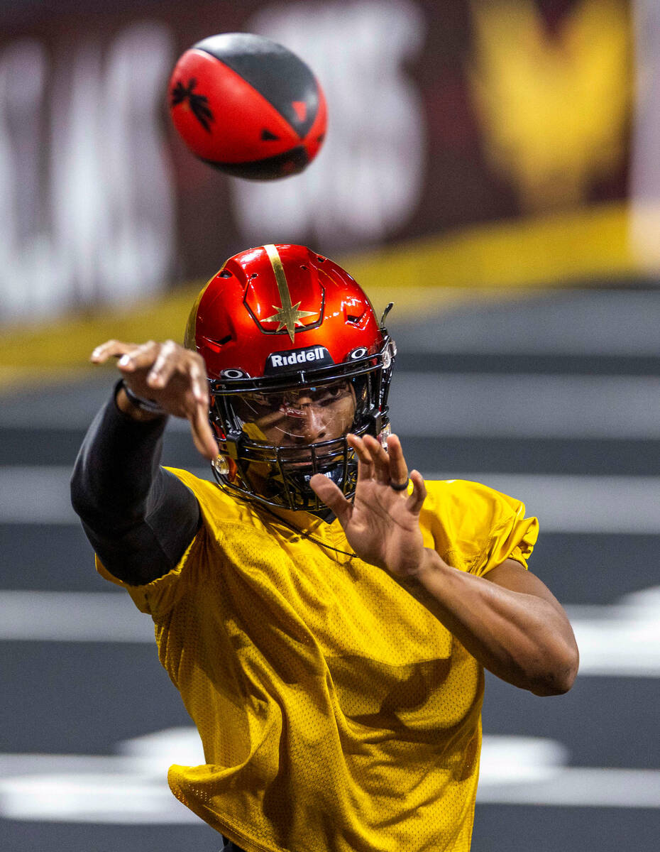 Vegas Knight Hawks quarterback Daquan Neal releases a pass during practice at The Dollar Loan C ...