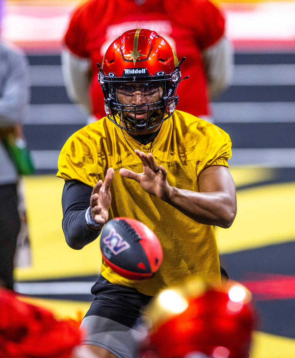 Vegas Knight Hawks quarterback Daquan Neal takes a snap during practice at The Dollar Loan Cent ...