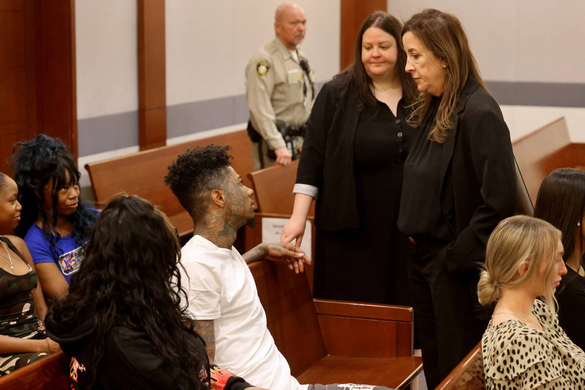 Johnathan Jamall Porter, also known as the rapper Blueface, talks to his attorneys Kristina Wil ...