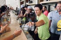 Actor and entrepreneur Mark Wahlberg is shown pouring shots of his Flecha Azul tequila at KAOS ...