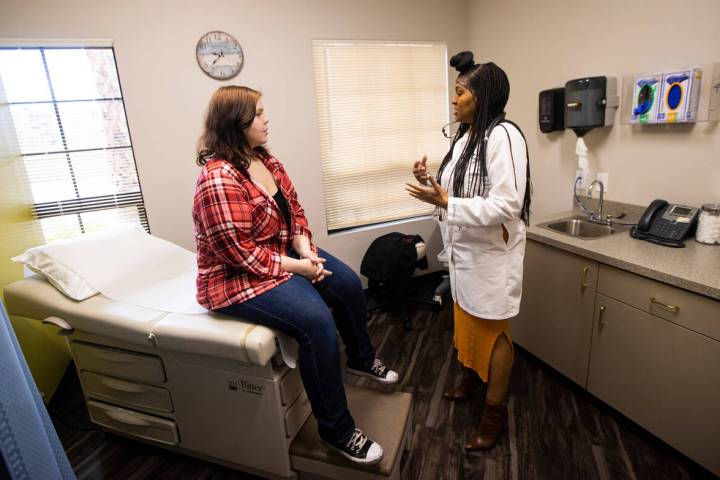 Lilnetra Grady, chief medical officer at FirstMed Health and Wellness Center, right, talks with ...