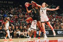Las Vegas Aces guard Jackie Young (0) grabs the ball for a rebound as Chicago Sky forward Alann ...