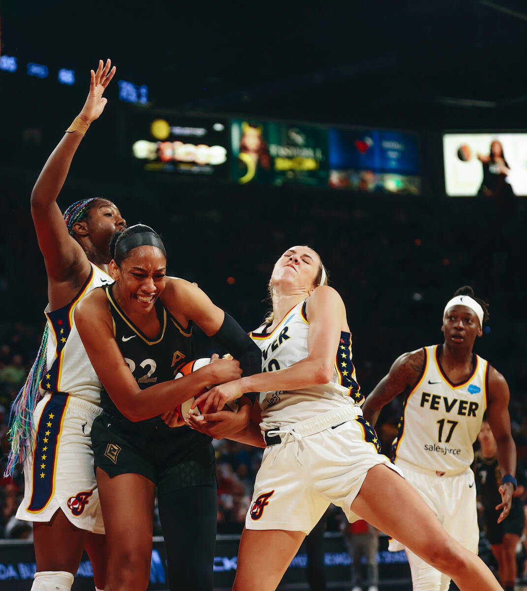 Las Vegas Aces center A’ja Wilson (22) fights with Indiana Fever guard Lexie Hull (10) f ...