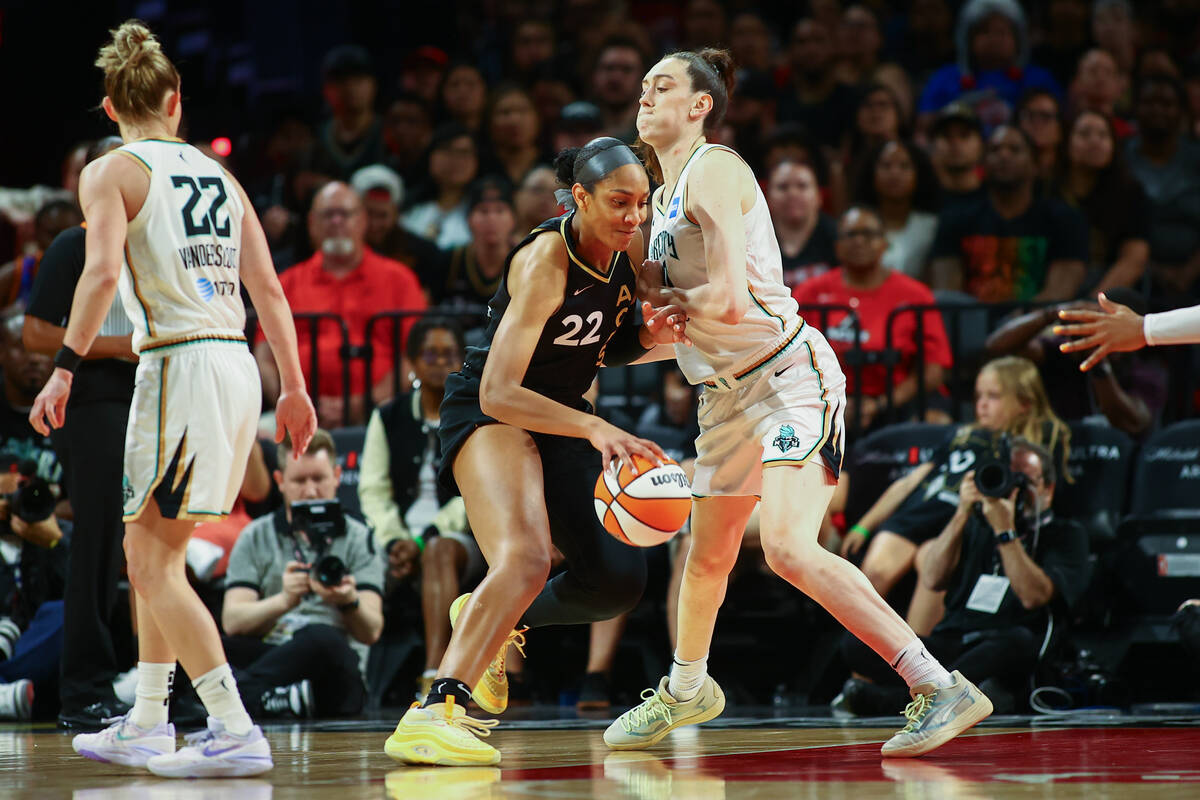 Las Vegas Aces forward A'ja Wilson (22) drives around New York Liberty forward Breanna Stewart ...