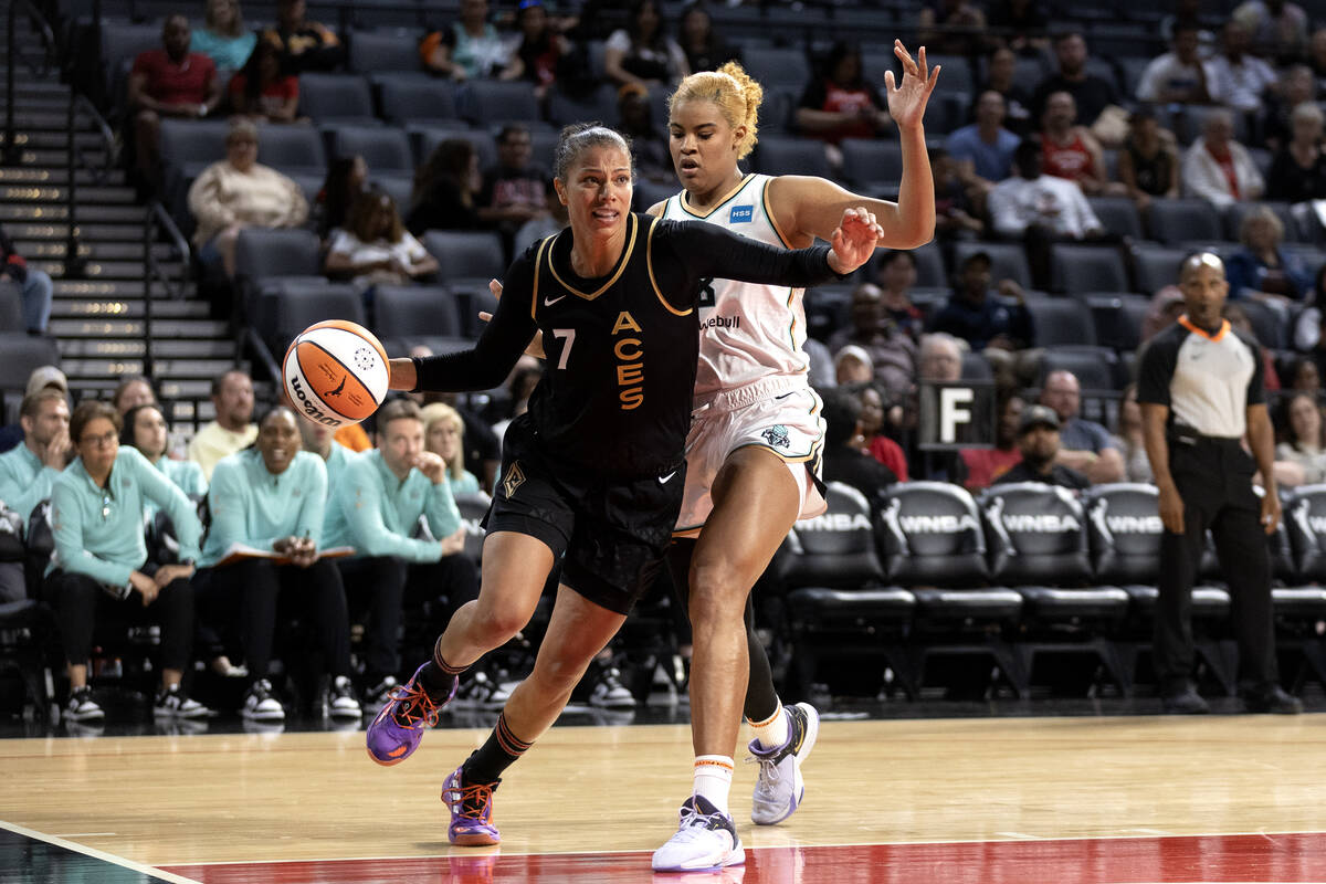 Las Vegas Aces forward Alysha Clark (7) drives toward the hoop while New York Liberty forward N ...