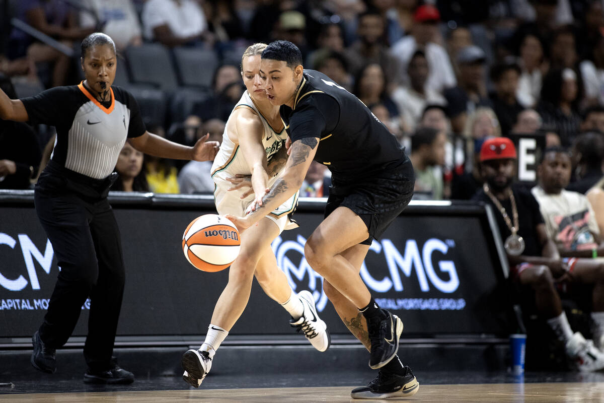 New York Liberty guard Marine Johannes (23) and Las Vegas Aces guard Kierstan Bell (1) run for ...