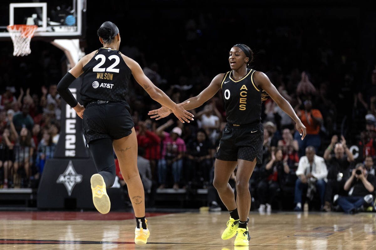 Las Vegas Aces forward A'ja Wilson (22) and guard Jackie Young (0) slap hands after Young shot ...