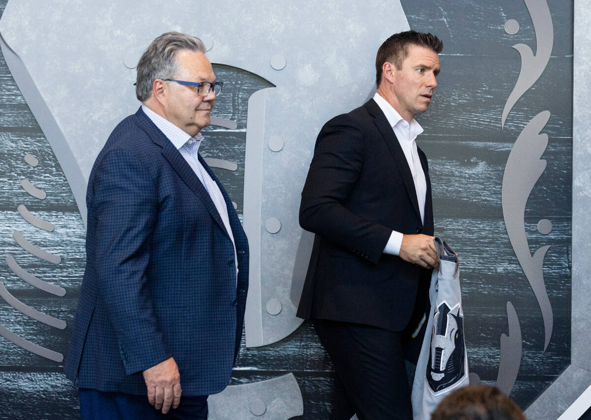 Golden Knights General Manager Kelly McCrimmon, left, takes the podium with Ryan Craig, to intr ...