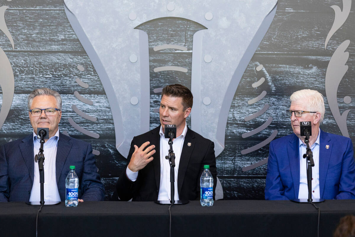 Ryan Craig, center, the new Silver Knights head coach, speaks as Golden Knights General Manager ...