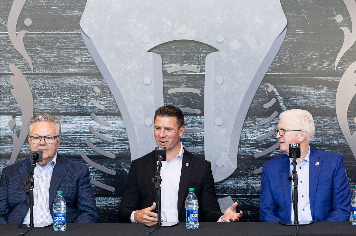 Ryan Craig, center, the new Silver Knights head coach, speaks as Golden Knights General Manager ...