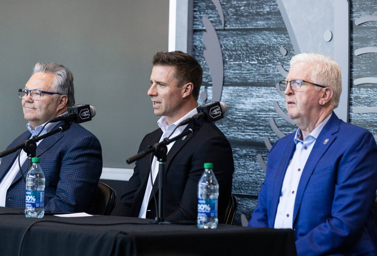 Ryan Craig, center, the new Silver Knights head coach, speaks as Golden Knights General Manager ...