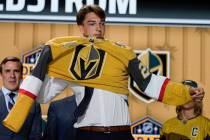 David Edstrom puts on a Vegas Golden Knights jersey after being picked by the team during the f ...