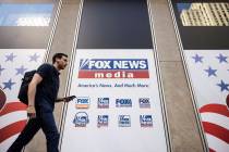 FILE - A person walks past the Fox News Headquarters in New York on April 12, 2023. A lawyer fo ...