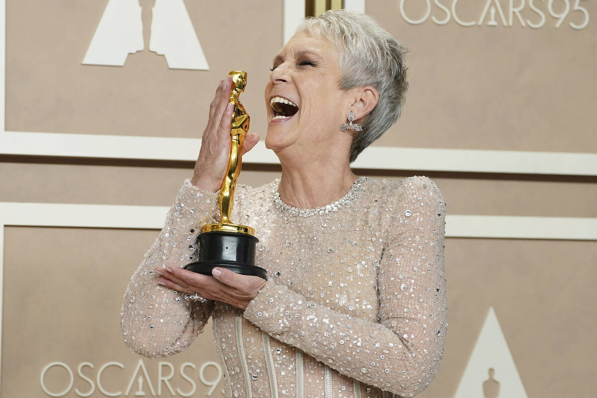 Jamie Lee Curtis poses with the award for best performance by an actress in a supporting role f ...