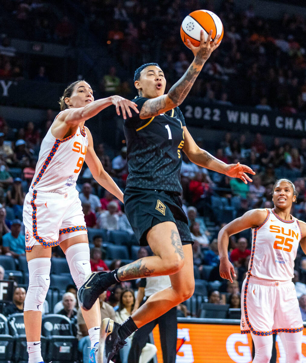 Las Vegas Aces guard Kierstan Bell (1) gets off a backwards shot past Connecticut Sun guard Reb ...