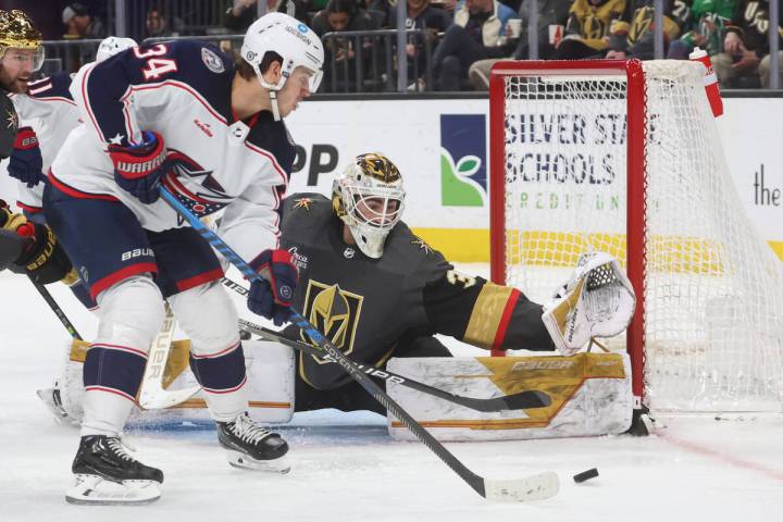 Golden Knights goaltender Jiri Patera (30) defends the net as Columbus Blue Jackets center Cole ...