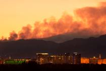 Smoke from the Carpenter 1 Fire rises over the Strip in Las Vegas on Tuesday, July 9, 2013. (Bi ...
