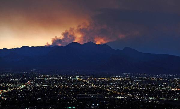 Smoke rises from the Carpenter 1 wildfire as the sun sets over Las Vegas on July 9, 2013. The N ...