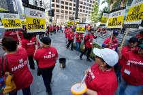 Striking hotel workers rally outside the Intercontinental Hotel after walking off their job ear ...