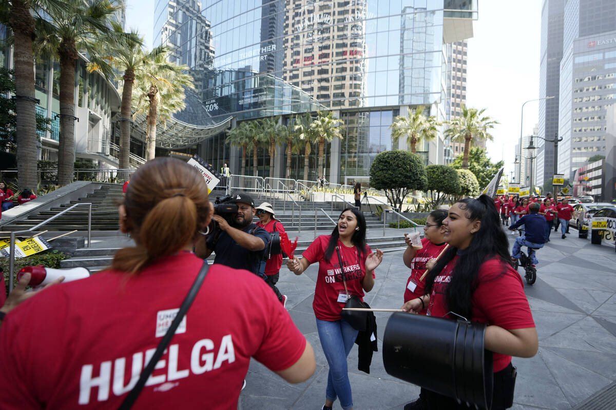 Striking hotel workers rally outside the Intercontinental Hotel after walking off their job ear ...