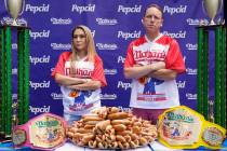 Competitive eaters Miki Sudo, left, and Joey Chestnut pose for a photograph during a weigh-in c ...