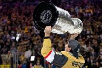 Golden Knights defenseman Zach Whitecloud (2) celebrates with the Stanley Cup after winning the ...