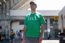 An Oakland Athletics fan wears a shirt labeled 'SELL' during a regular season game between the ...