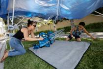 Elizabeth Guereque of Summerlin sets up a tent with her son Christian, 12, Monday, July 3, 2023 ...