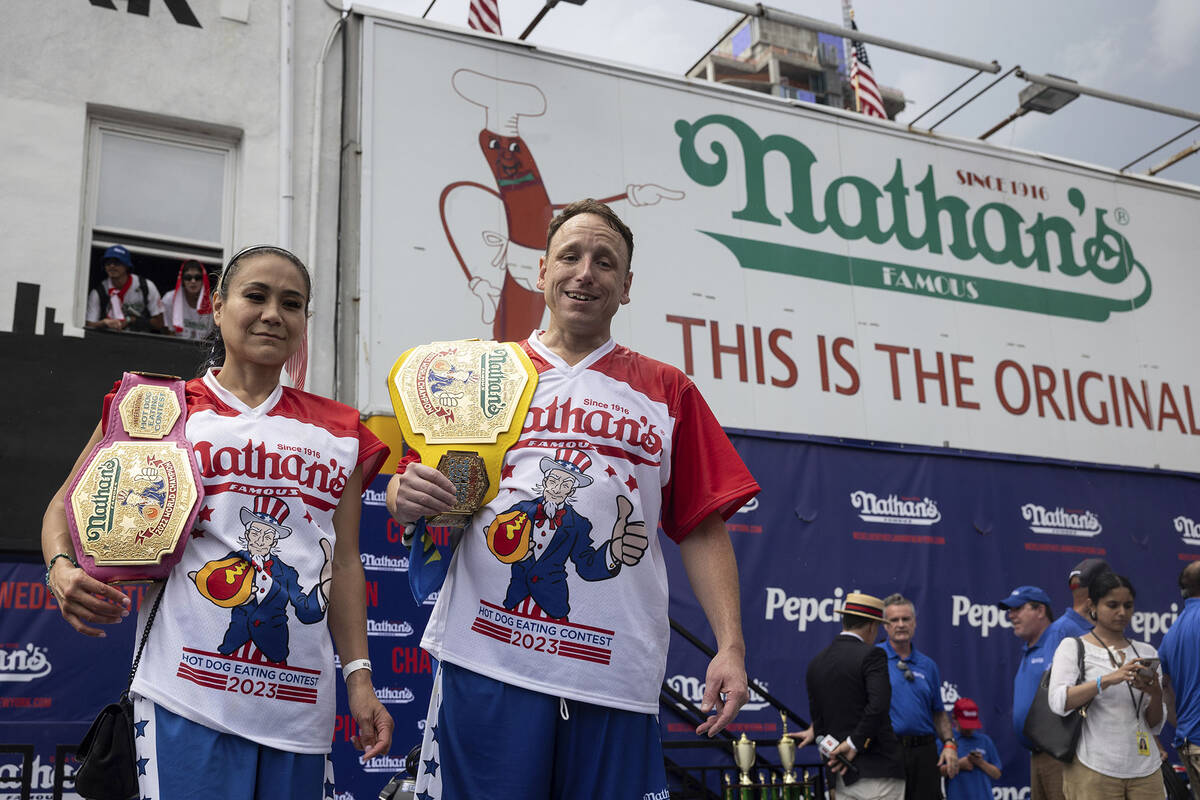 This year's woman's champion Miki Sudo, left, and man's champion Joey Chestnut, right, stand to ...