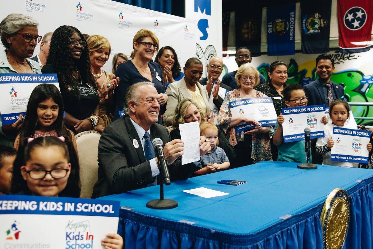 Nevada Gov. Joe Lombardo holds up a bill that he signed to approve the Keeping Kids in School A ...
