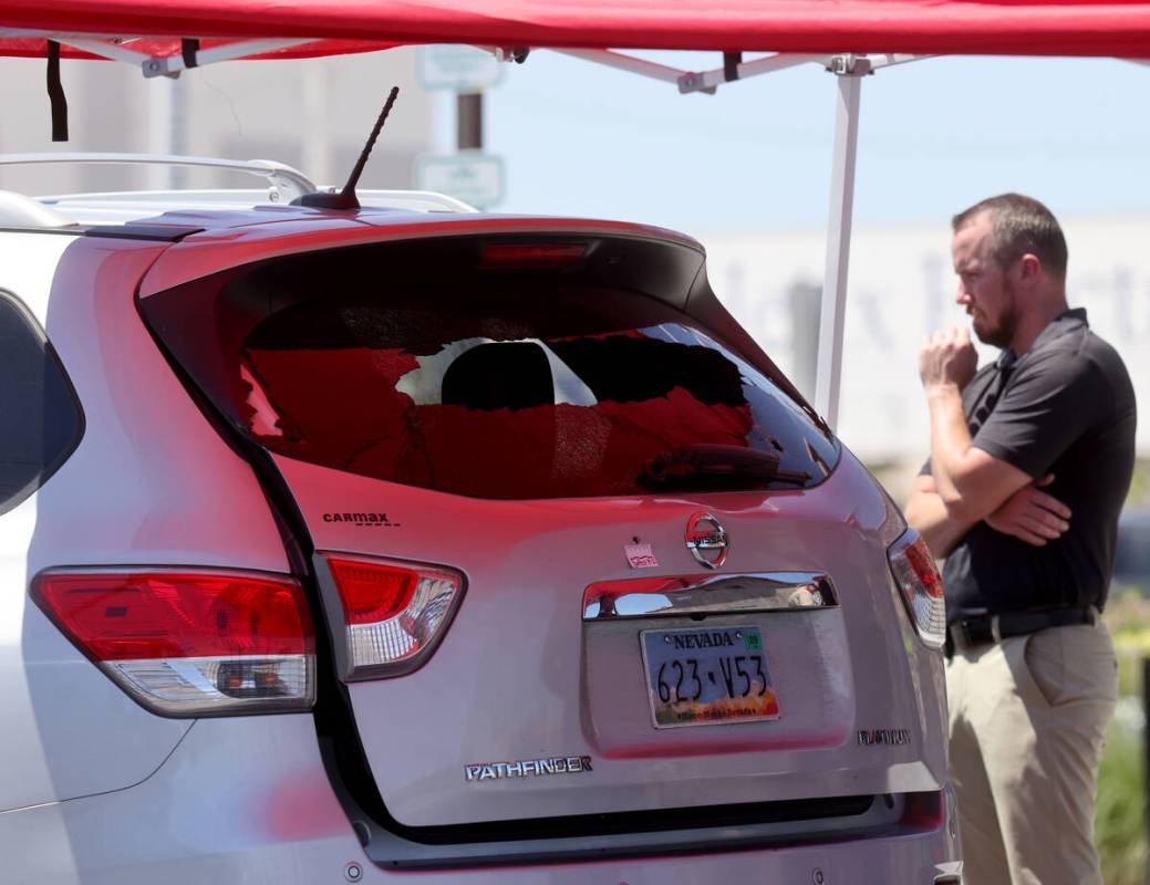 A car window is broken as North Las Vegas Police investigate where a 6-year-old girl and man in ...
